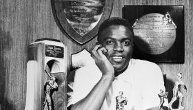 Jackie Robinson at Home With his Various Trophies
