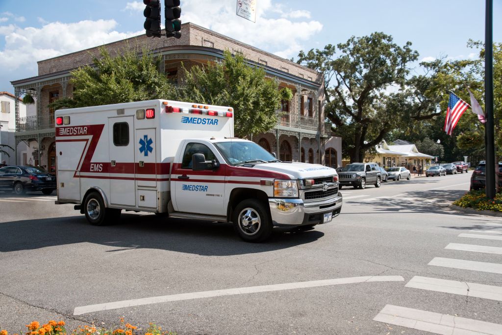 Alabama USA, An ambulance on an emergency call trailing through the town center