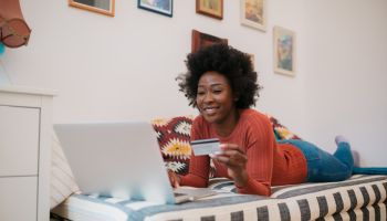 Attractive African American woman checking her bank account online