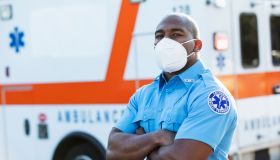 Paramedic in front of ambulance, with face mask