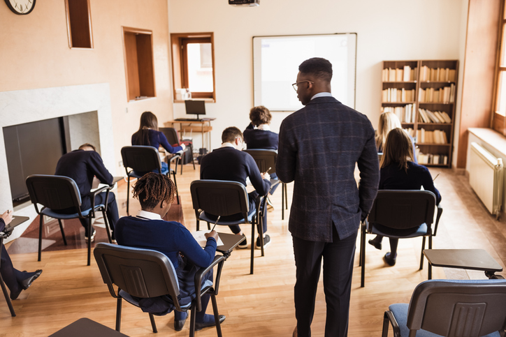 Teacher supervising the class during a school exam