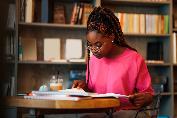 Black student having a study session at a cafe table