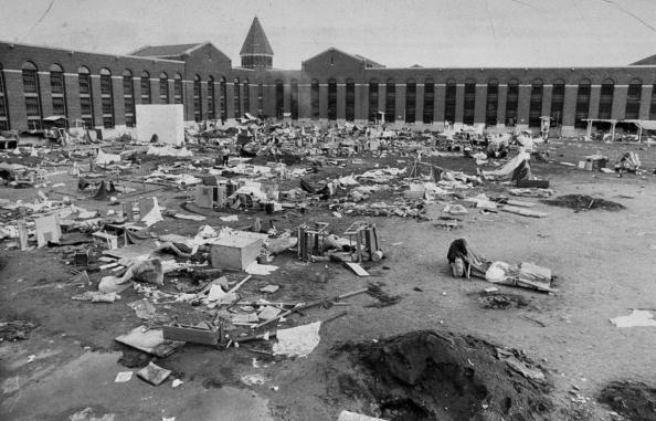 Mattresses, crates and rubble fill the yard after riots at A
