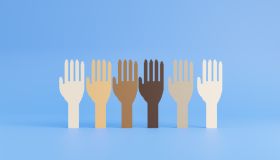 Row of raised hand symbols of various races. Flat computer graphic on blue background.