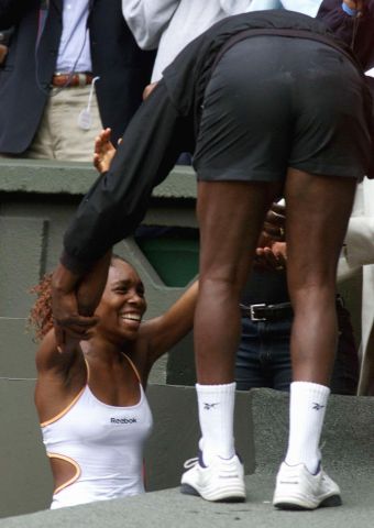 US player Venus Williams reaches up to her father