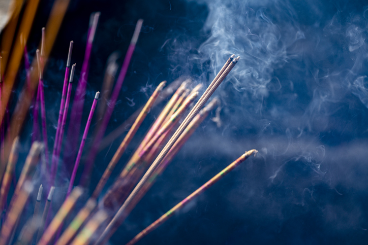 Incense sticks burning with smoke in a buddhist temple in China