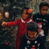 Children playing with sparklers in fairy forest on Christmas.
