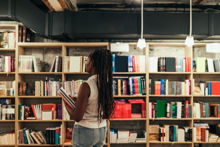 Woman looking for some good book in library