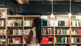 Woman looking for some good book in library