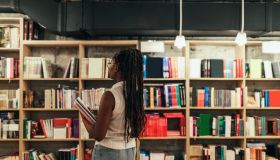 Woman looking for some good book in library