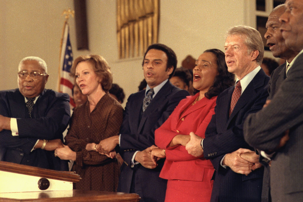 Jimmy Carter and Rosalynn Carter sing with Martin Luther King Sr. Coretta Scott King Andrew Young and other civil rights leader during a visit to Ebenezer Baptist Church in Atlanta circa 14 January 1979