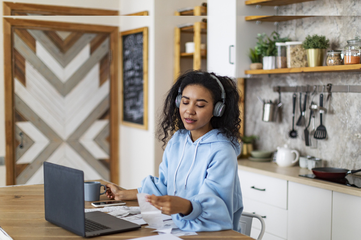 Young African woman working with finance at home