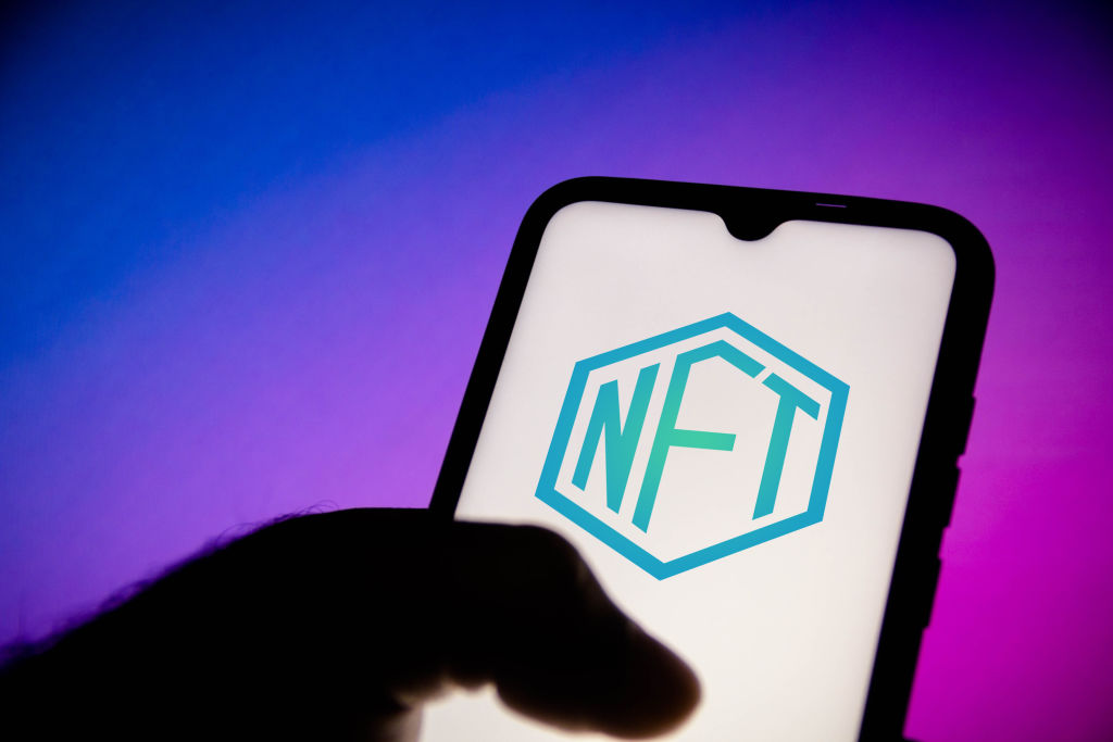 In this photo illustration, a NFT (Non-fungible token) logo...