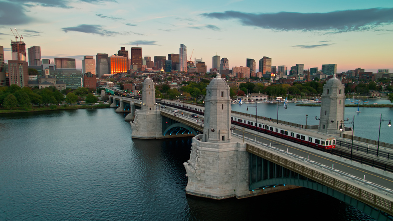 Aerial Shot of Red Line Train Headed from Boston to Cambridge Across Longfellow Bridge at Sunset