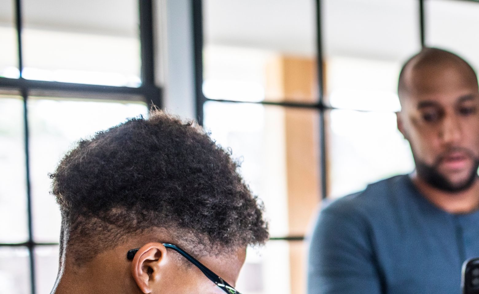 Tween boy using digital tablet in residential kitchen