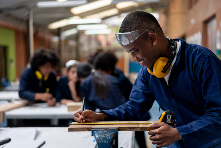 Industrial design student building furniture at a workshop in class