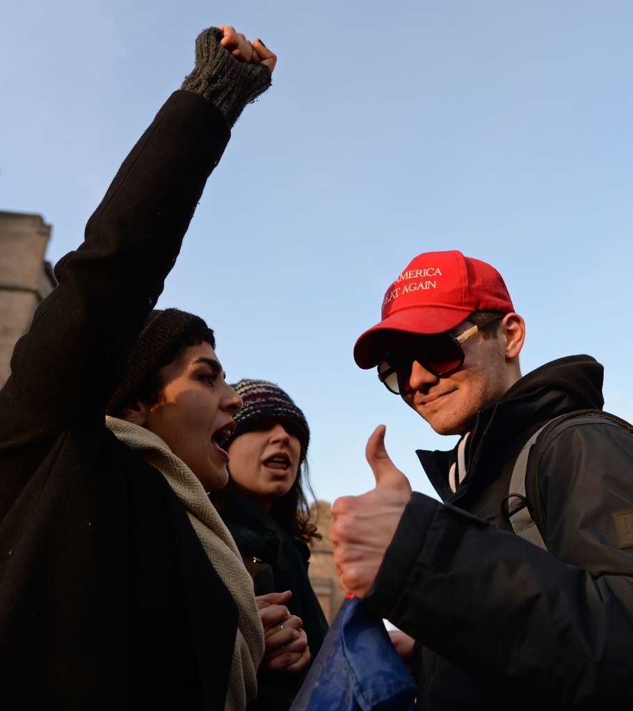 (Boston, MA) Demonstrators Anisa Hosseinnezhad, left, and Samantha Corsini, both students at MassArt, debate their political views with Boston University student Nick Fuentes, a supporter of President Donald Trump during a rally at BU against Trump's