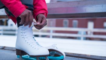 African American woman putting on ice skate