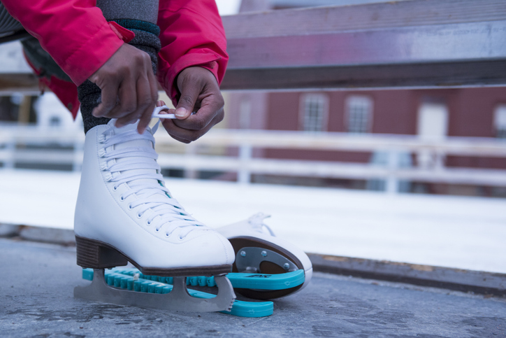 African American woman putting on ice skate