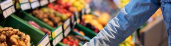 Woman buying fresh vegetables at supermarket