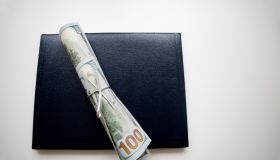 school diploma wrapped in $100 bills & traditional leather diploma binder