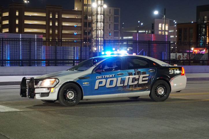 Close-up of a Detroit police vehicle with flashing lights.
