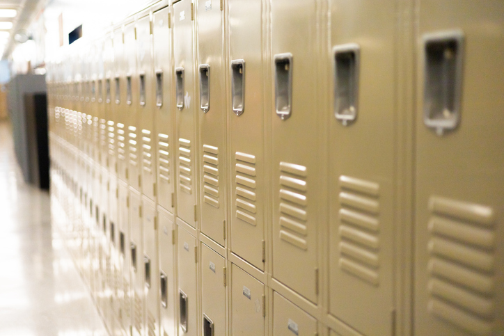 diminishing perspective of row of traditional metal school lockers