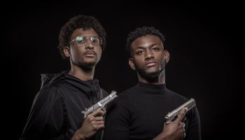 Portrait of two armed young black males in studio shoot