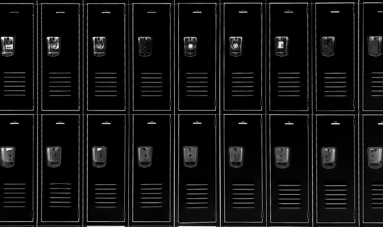 american epidemic of gun violence, debate over school safety initiatives & second amendment protections: row of 18 black traditional metal school lockers