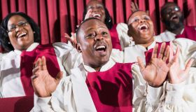 Mature black man with group, singing in church choir