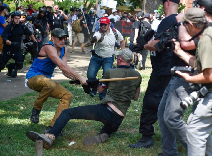A member of the white supremacist and a protester are seen fighting.