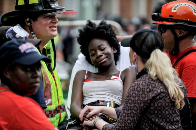 A young woman is surrounded by the rescue team.