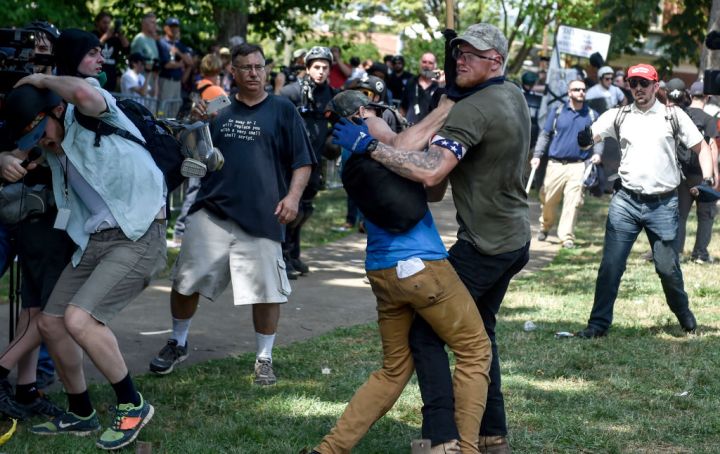 A member of the white supremacist and a protester are seen...