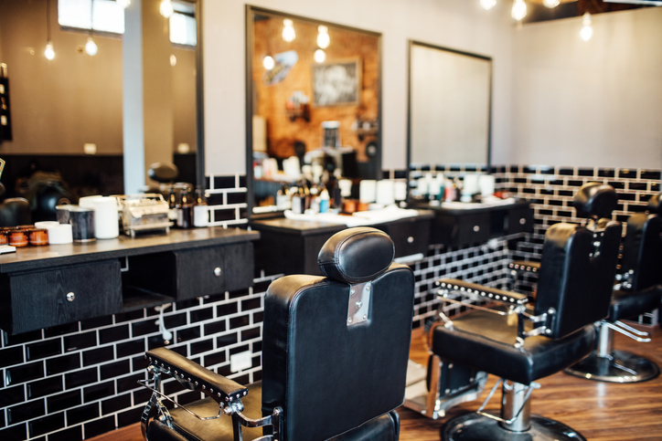 Empty black chairs and mirrors in the barbershop