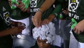 Iowa little league baseball player covered with cotton by white teammates