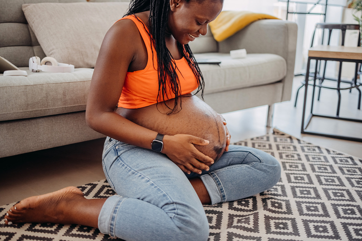 Pregnant woman touching her belly