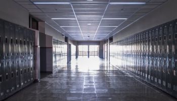 Empty high school corridor with lockers lining the walls
