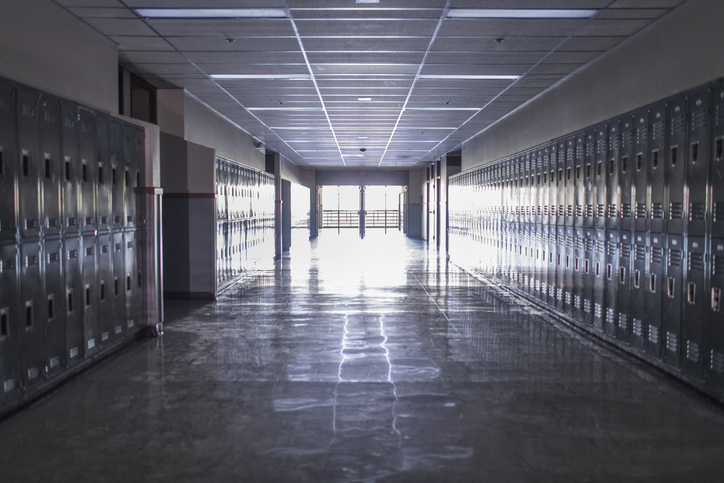 Empty high school corridor with lockers lining the walls