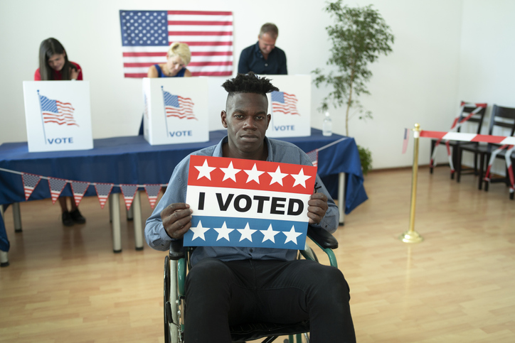 Young handicapped Afro-American man on Election Day