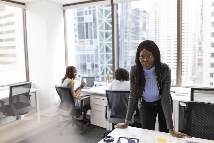 Portrait confident businesswoman working in highrise office