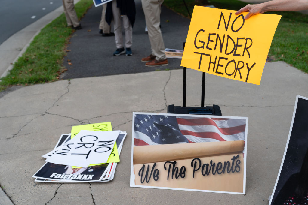 FALLS CHURCH, VA - JULY 17: A woman holds a no gender theory si