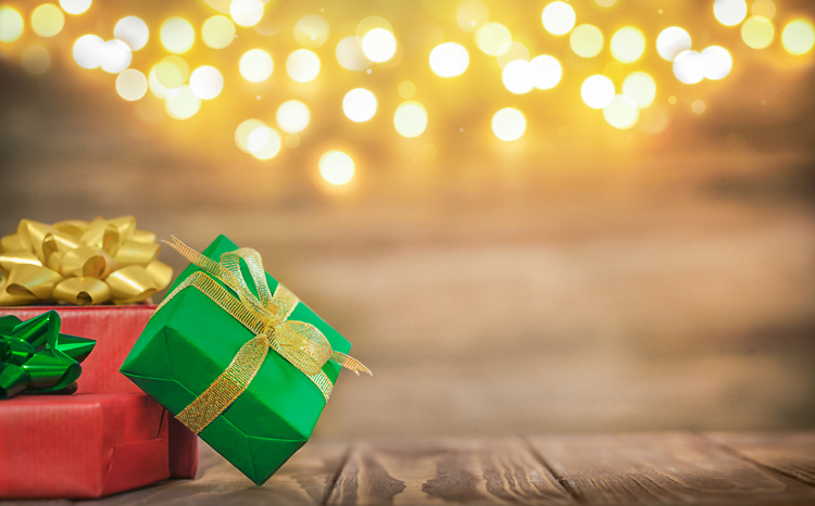 three gift boxes on a wooden background with bokeh, space for text