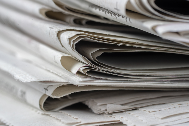 Closeup shot of newspapers stacked on top of each other