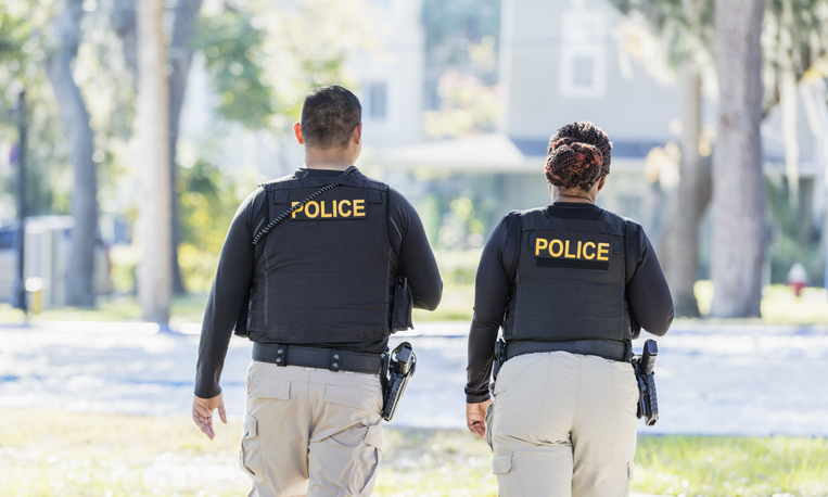 Two police officers walking in community