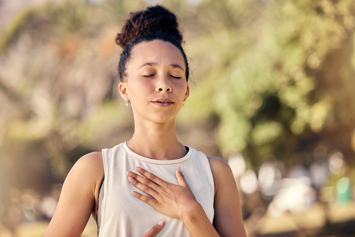 Yoga, meditation and fitness with a black woman breathing for calm exercise outdoor in a nature park. Wellness, health and meditate with a female yogi finding peace, balance or zen alone outside
