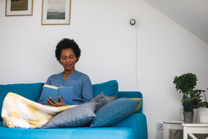 Front view of happy mid adult woman enjoying reading an interesting book