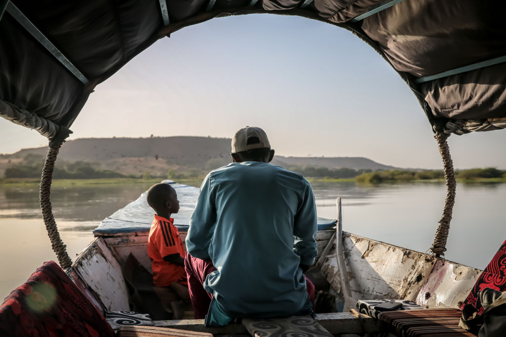 A man rows his boat along the Niger River in Niamey...
