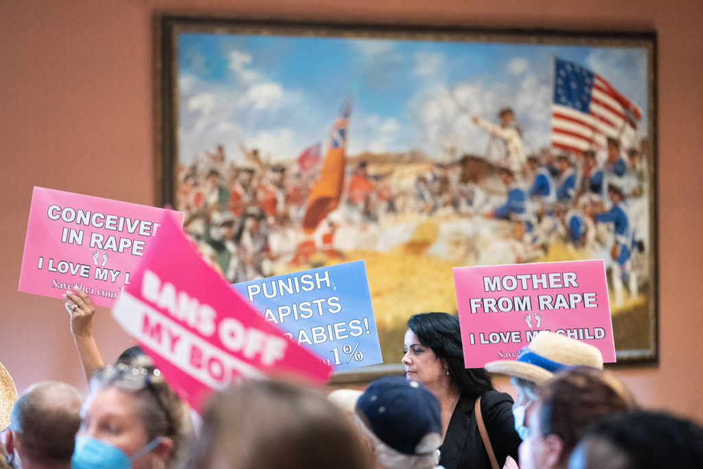 Protesters hold signs inside the South Carolina Statehouse...