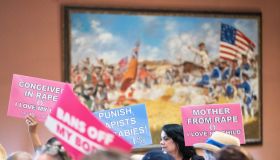 Protesters hold signs inside the South Carolina Statehouse...