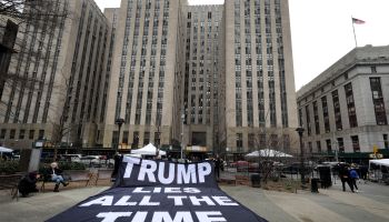 Demonstrators unfurl a banner near Manhattan Criminal Court